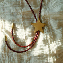 Load image into Gallery viewer, Handmade brass and leather bolo featuring a layered star center and hammer texture